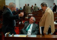 N.C. Rep. Roger West (center), a Republican who represents Cherokee, Clay, Graham and Macon counties, chats with state Rep. Bill Owens, D-Pasquotank, and lobbyist Zeb Alley during a break on the House floor this spring.