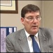 Buncombe County District Attorney Ron Moore, pictured last year with a portion of the unreleased Asheville Police Department's evidence-room audit. Image courtesy of WSPA.