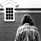 Woman outside a home; stock image.
